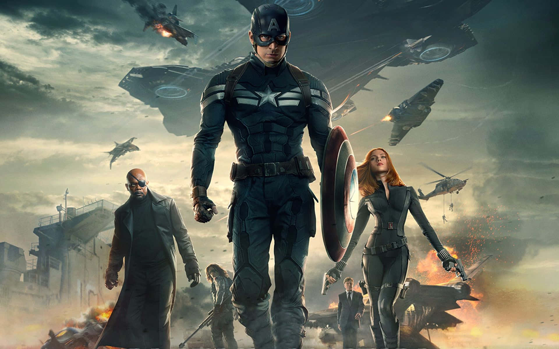 Best Captain America 桌布 壁紙 — 美國隊長帶領團隊穿越戰區，戰鬥機和直升機在倒塌的建築物上空交戰。