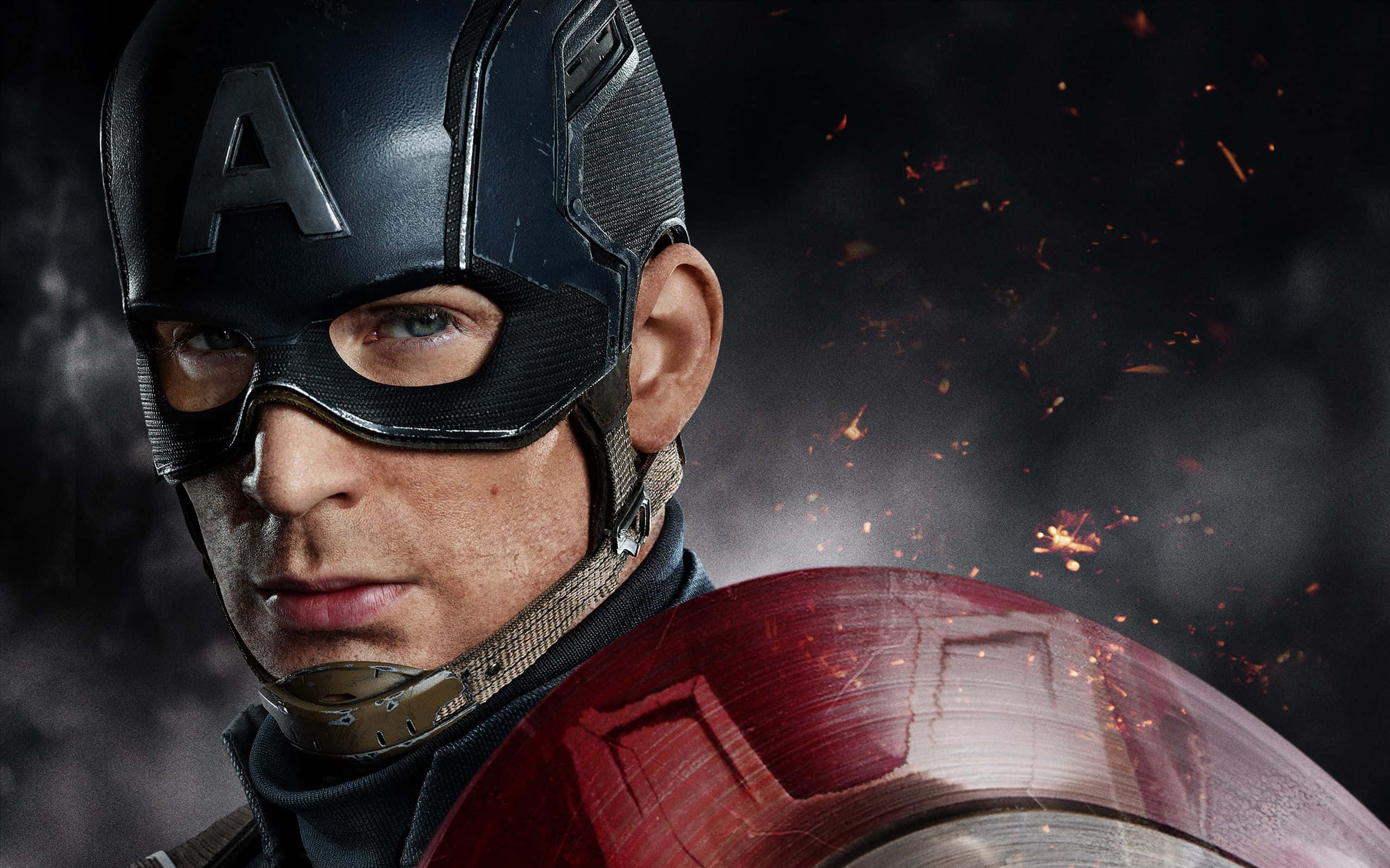 Best Captain America 桌布 壁紙 — 美國隊長手持標誌性盾牌，在飛濺的火花和黑煙背景下凝視前方。