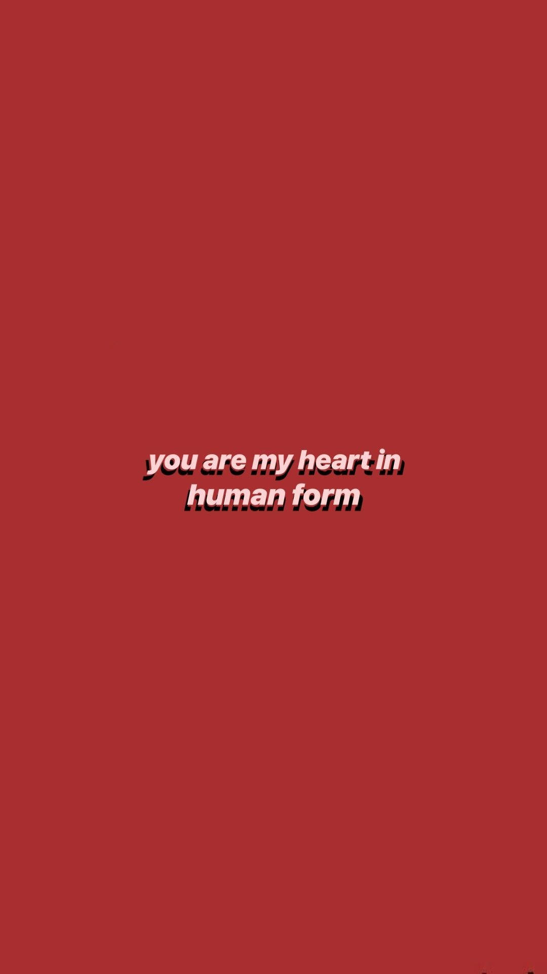 美學語錄：你是我的心 壁紙 — 粗體白色文字寫著「你是我心中的人類形態」，居中在純深紅色背景上。