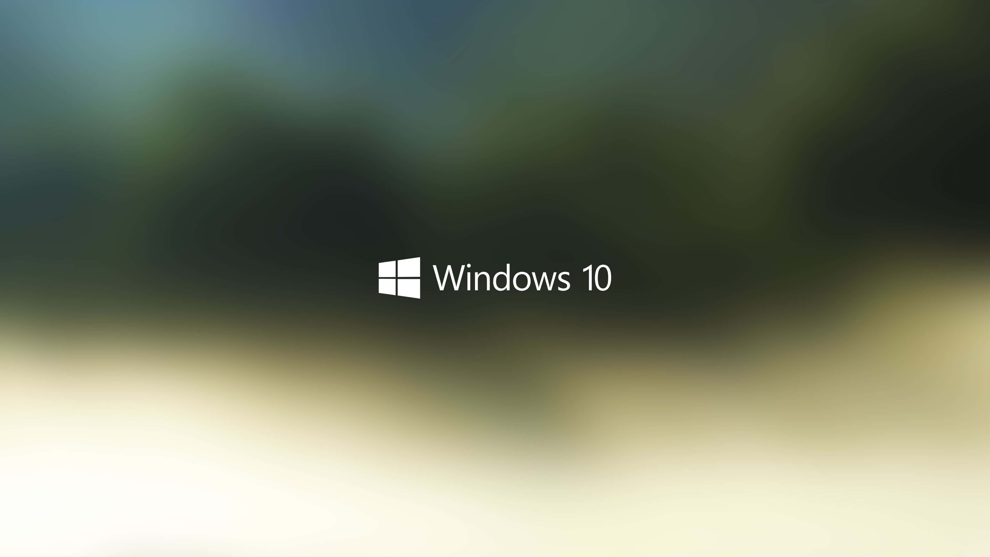 美麗的 Windows 10 桌面背景 壁紙 — Windows 10 標誌居中於模糊的漸變背景上，顏色為青綠色和米色。