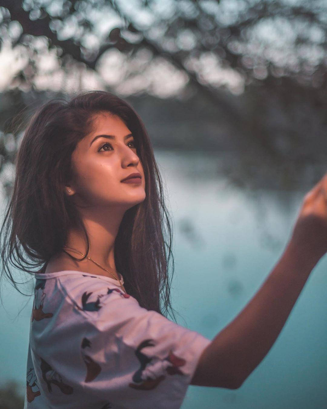 年輕女性在湖邊抬頭仰望