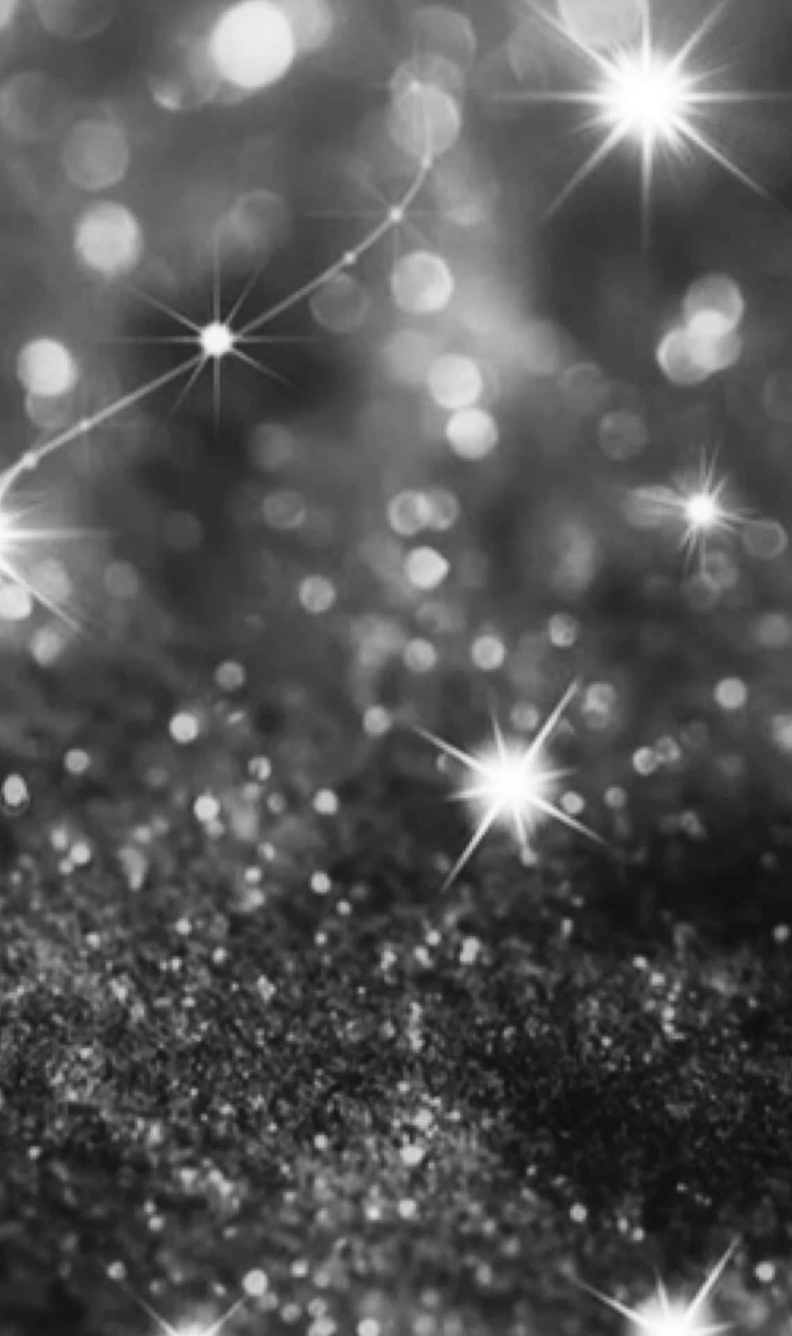 黑白閃粉，帶有閃爍星芒光線和柔和模糊圓圈。