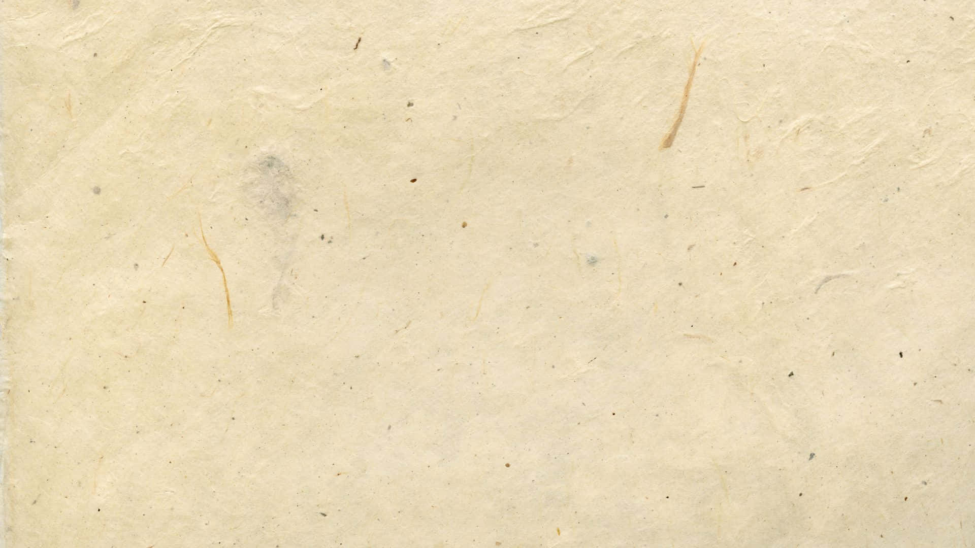 Old Paper Texture 桌布 壁紙 — 老化嘅奶油色手工紙嘅特寫，有可見嘅纖維同微妙嘅污漬。