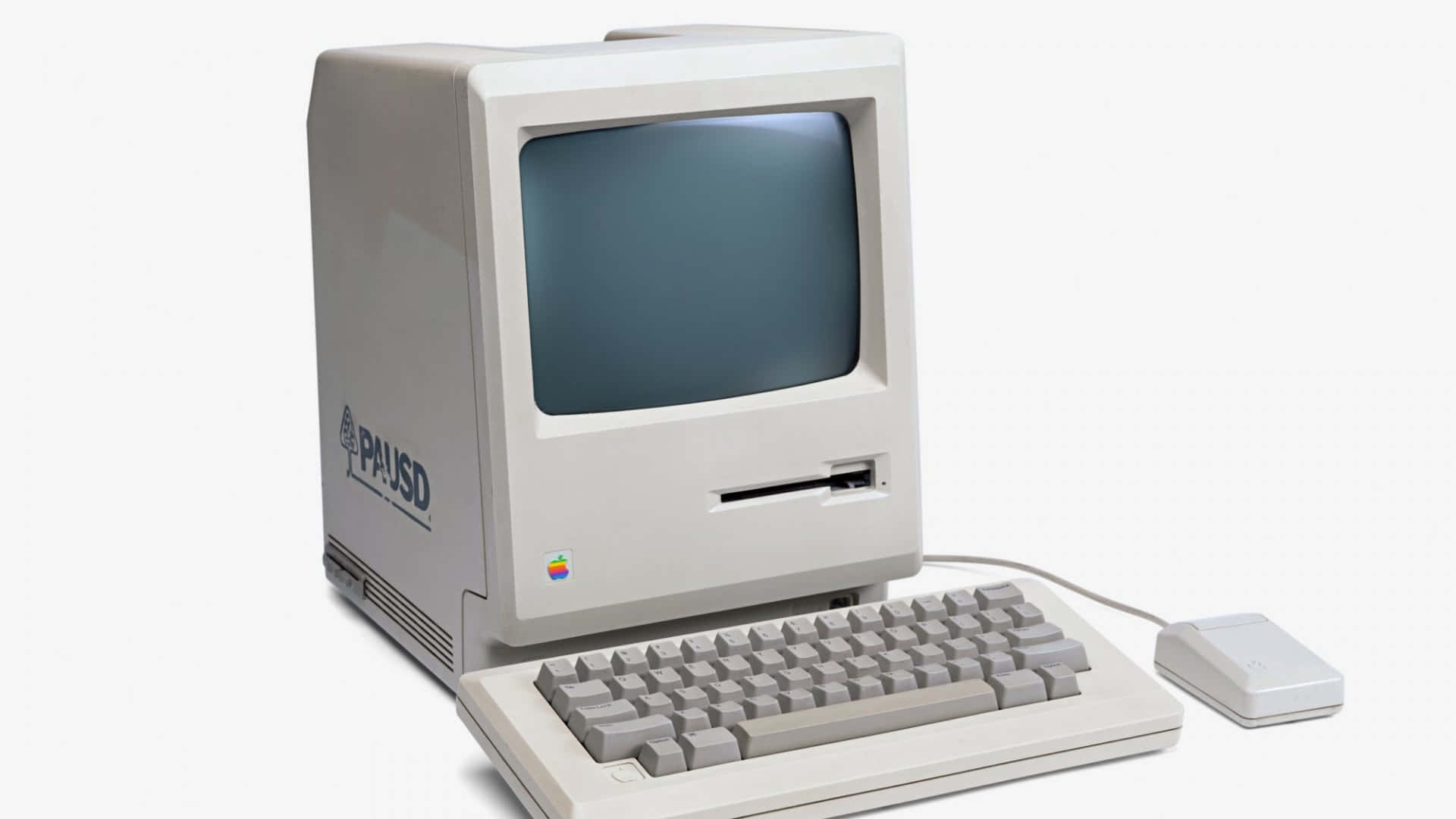 復古米色 Apple Macintosh 電腦，帶有集成顯示器鍵盤和鼠標。