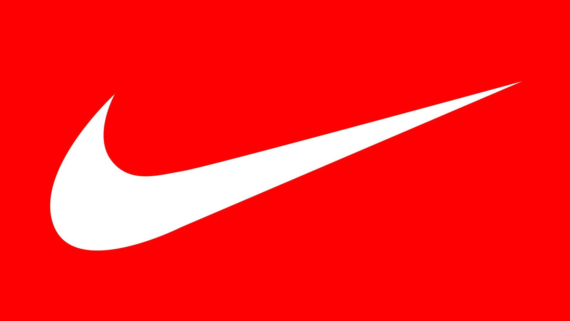 耐克女孩白色Swoosh標誌 壁紙 — 一個大膽的白色Nike Swoosh標誌，居中在鮮豔的純紅色背景上。