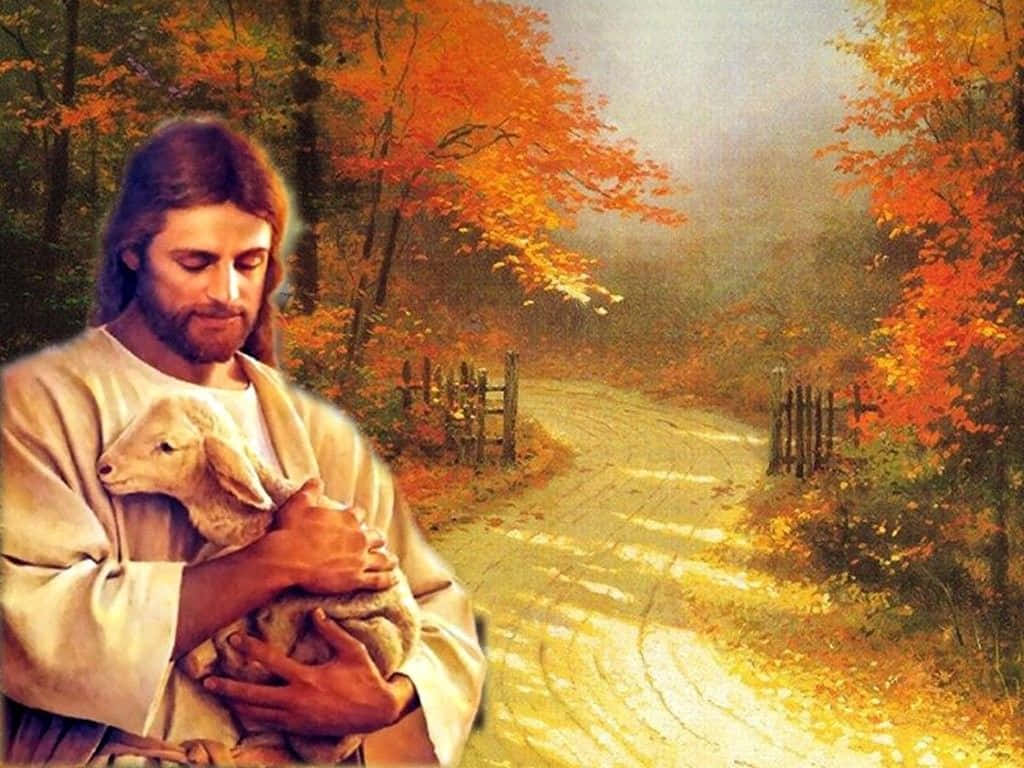 Jesus With Sheep 桌布 壁紙 — 耶穌在陽光明媚的秋日小徑上懷抱羔羊，小徑兩旁是火紅的橙樹和霧氣瀰漫的森林。