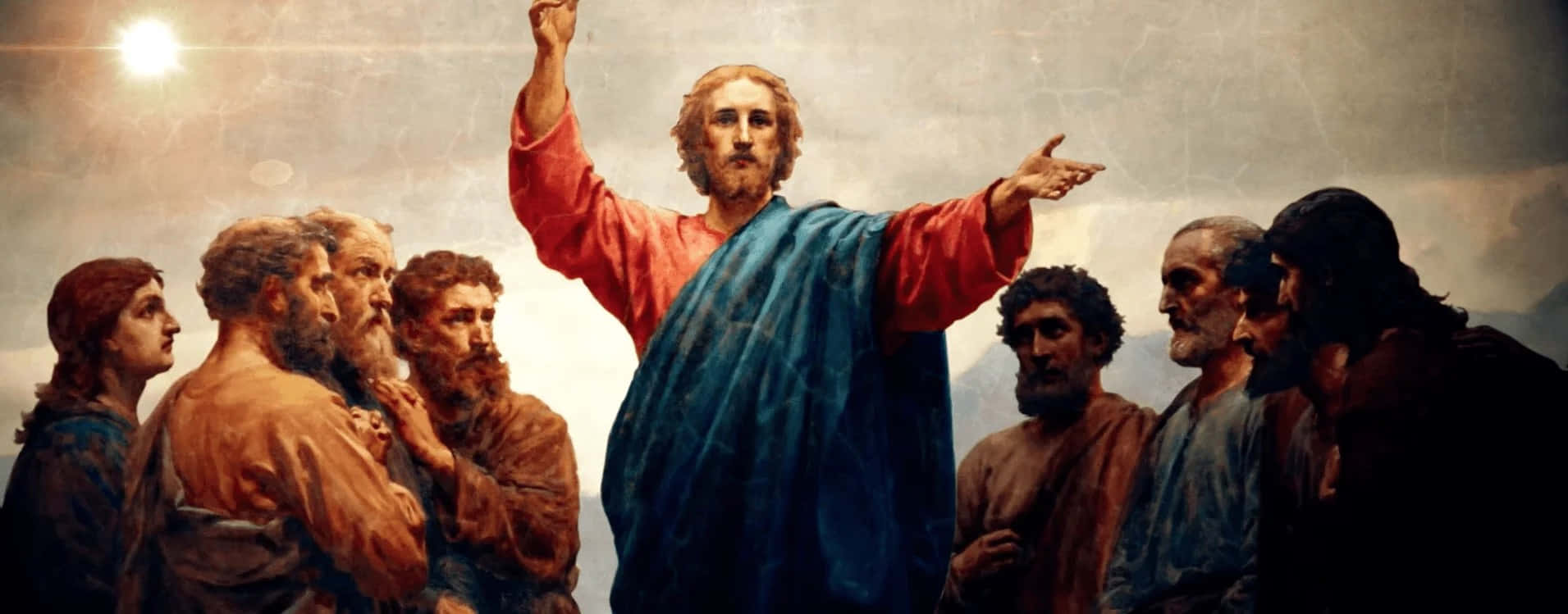 Jesus Disciples 桌布 壁紙 — 耶穌身穿紅袍和藍色斗篷，向上方做手勢，門徒們聚集在他周圍，沐浴在明亮的天光之下。