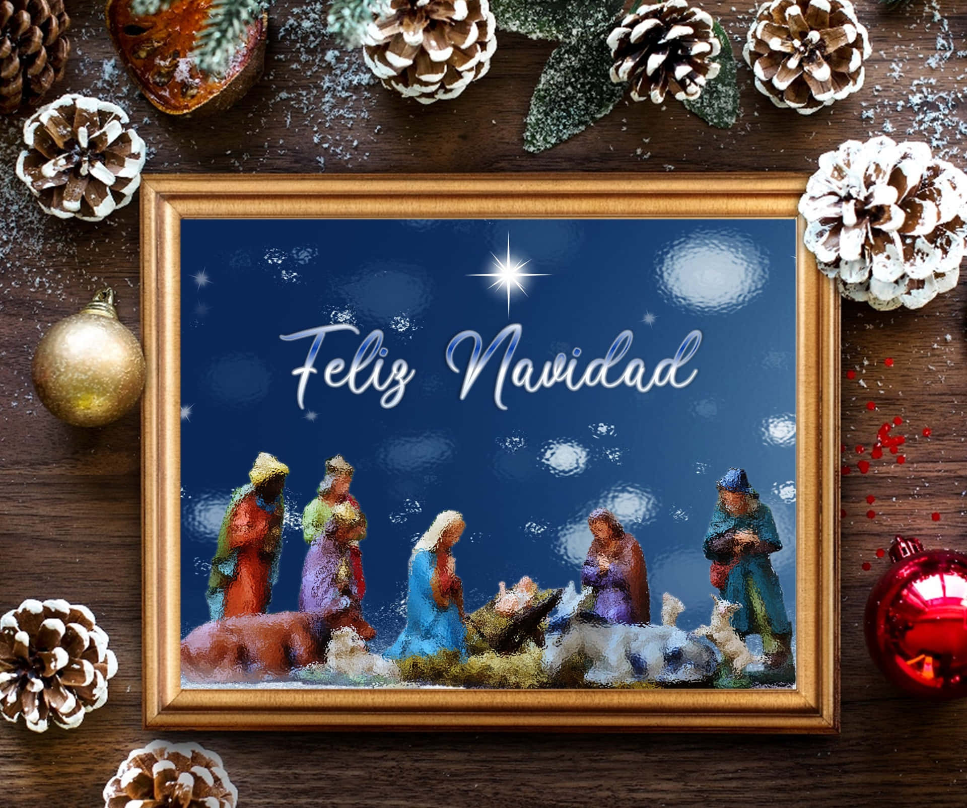 裱框耶穌誕生場景，帶有 'Feliz Navidad'，周圍環繞松果和裝飾品。