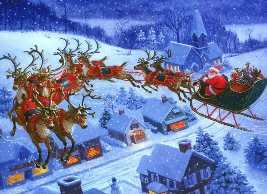 Santa Claus 桌布 壁紙 — 聖誕老人乘坐由馴鹿拉動的雪橇，在夜晚飛越一個積雪覆蓋的村莊，窗戶閃爍著光芒，雪花飄落。