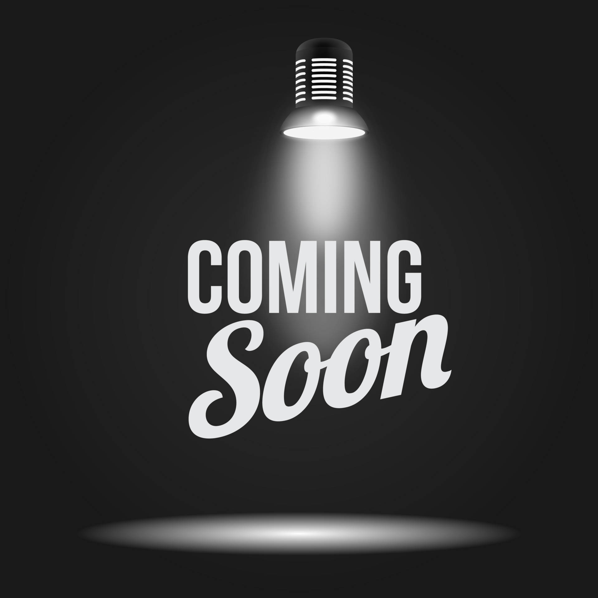 聚光燈照亮深色背景上的「COMING SOON」文字。