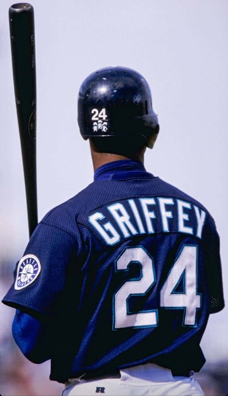 棒球手Griffey背號24穿藍色球衣在戶外手持球棒。
