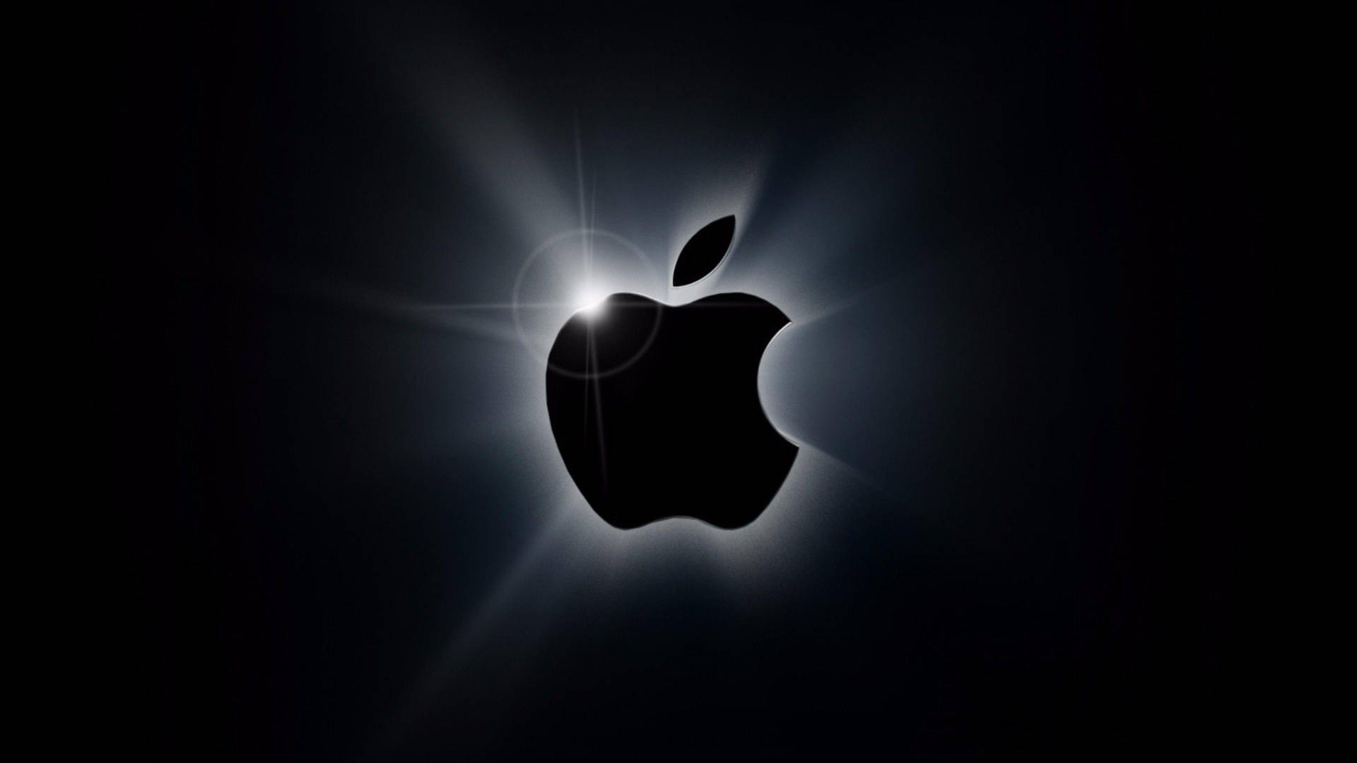 Apple標誌在黑色背景上發光，帶有鏡頭光暈