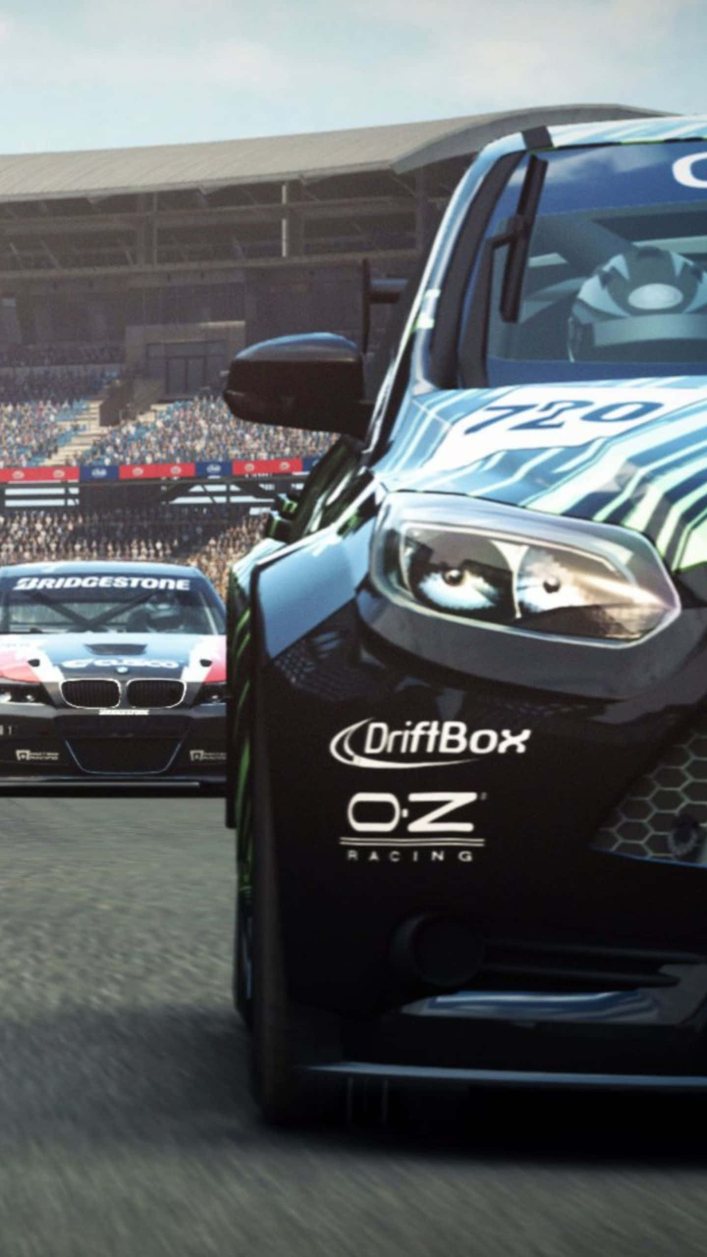 與 Android Grid Autosport 一起環遊世界賽道 壁紙 — 兩輛賽車在明亮的日光下，以座無虛席的體育場為背景，在賽道上競逐。