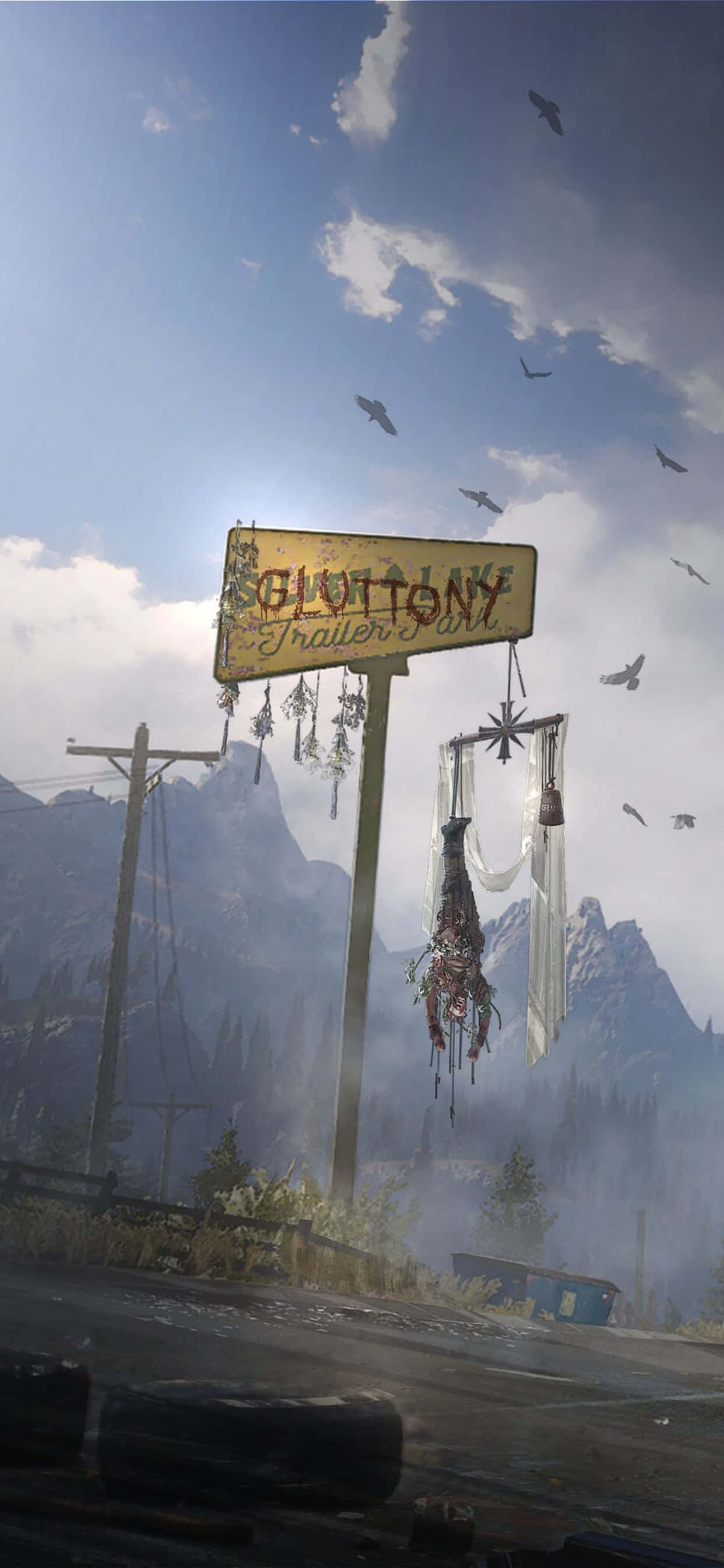 與 iPhone Xs Max 和《Far Cry 5》一起進入冒險世界 壁紙 — 一個風化的「Glottony Trailer Park」標誌歪斜地掛在一條荒涼的道路上，背景有山脈和鳥兒飛過。