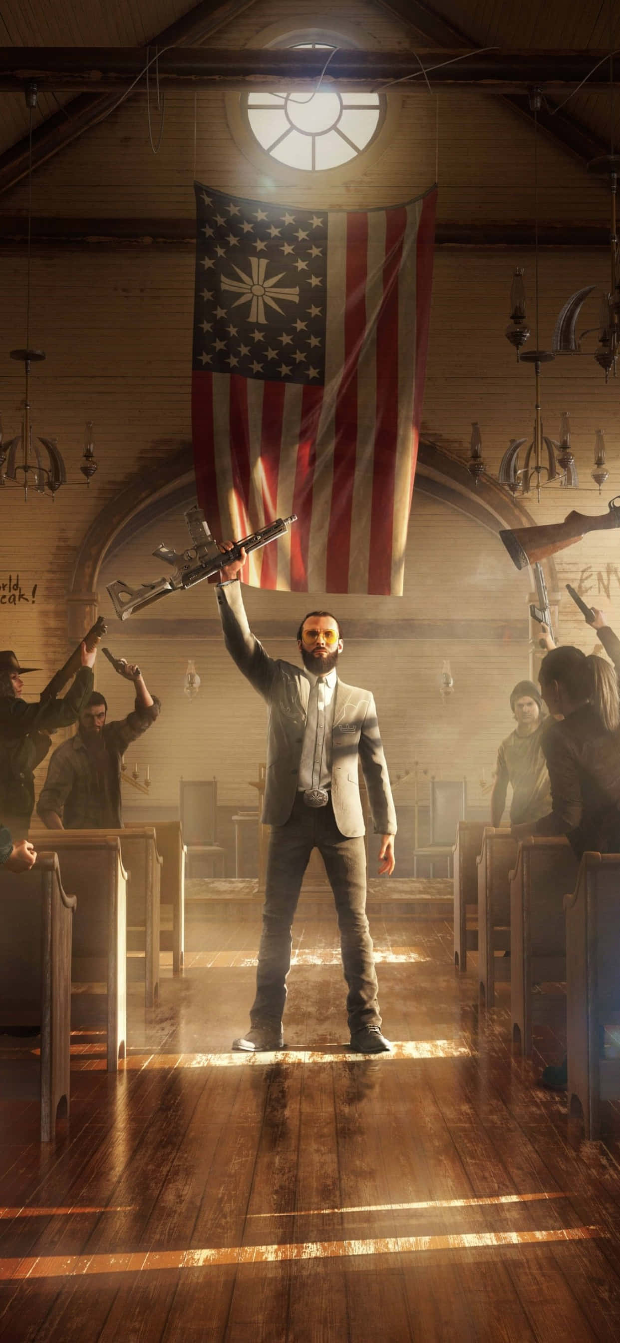 與 iPhone Xs Max 和《Far Cry 5》一起享受壯闊冒險 壁紙 — 一名身穿西裝的男子挑釁地站在木製教堂走廊上，手持步槍，被頭頂一盞燈照亮，身後掛著一面帶有十字架的美國國旗。