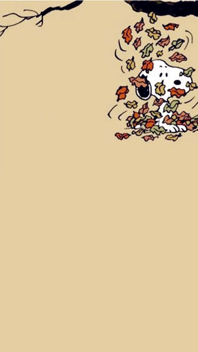 Snoopy 被樹枝下飄落的秋葉覆蓋。