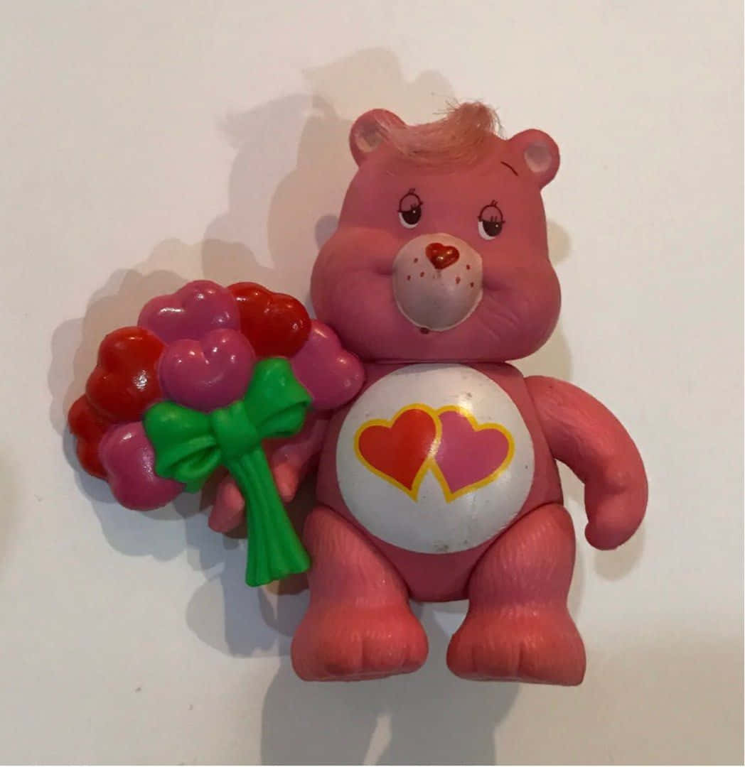 粉紅色Care Bear玩具拿著一個心形花束。