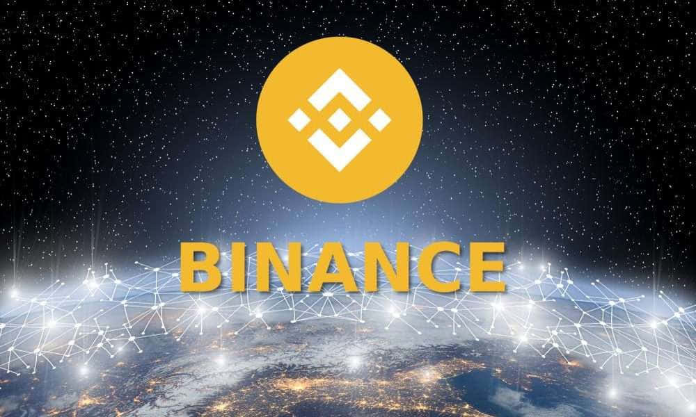 夜晚地球上面嘅發光全球網絡線同Binance標誌。
