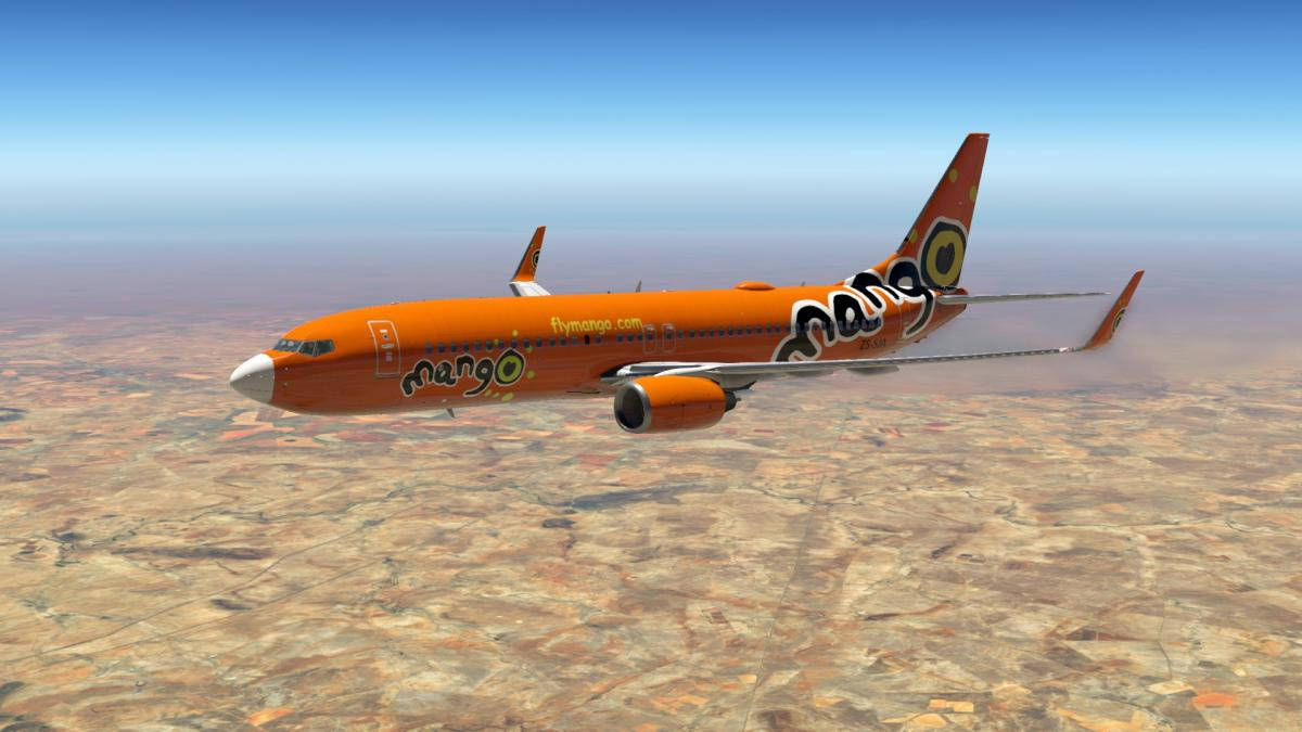 橙色芒果航空飛機飛越沙漠地形。