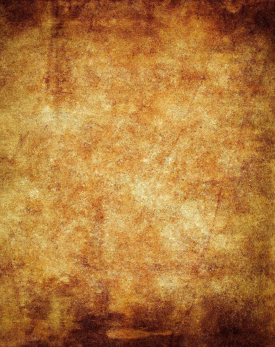 帶有溫暖金棕色調的復古紋理羊皮紙背景。