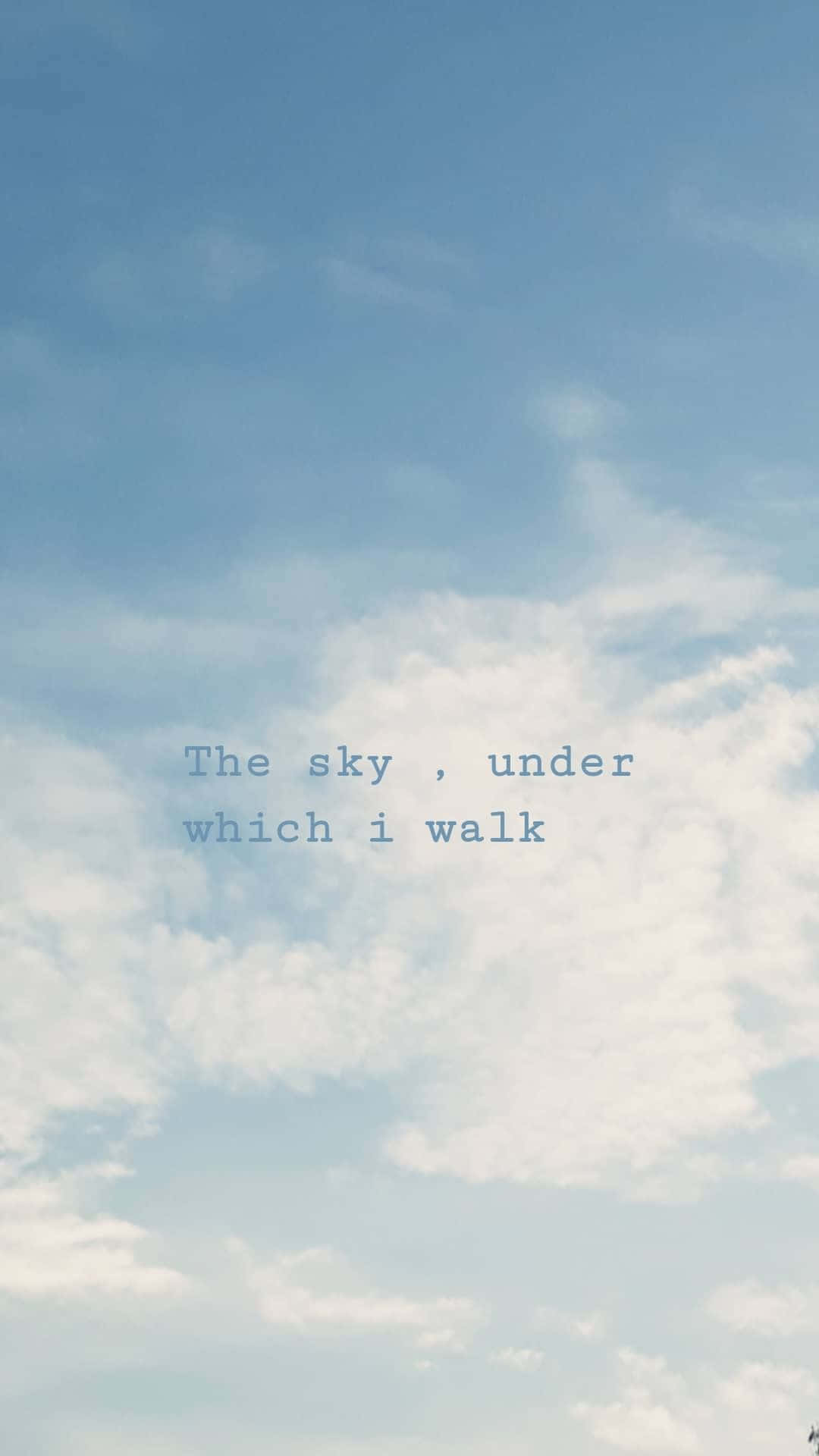 文字疊加顯示「The sky, under which i walk」，背景為多雲的藍天。
