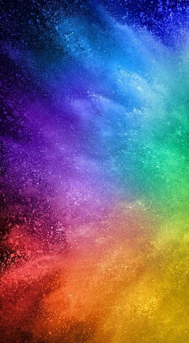 色彩爆發 壁紙 — 充滿活力的彩虹色粉末在深色背景上對角線爆炸，形成動態的抽象爆發。