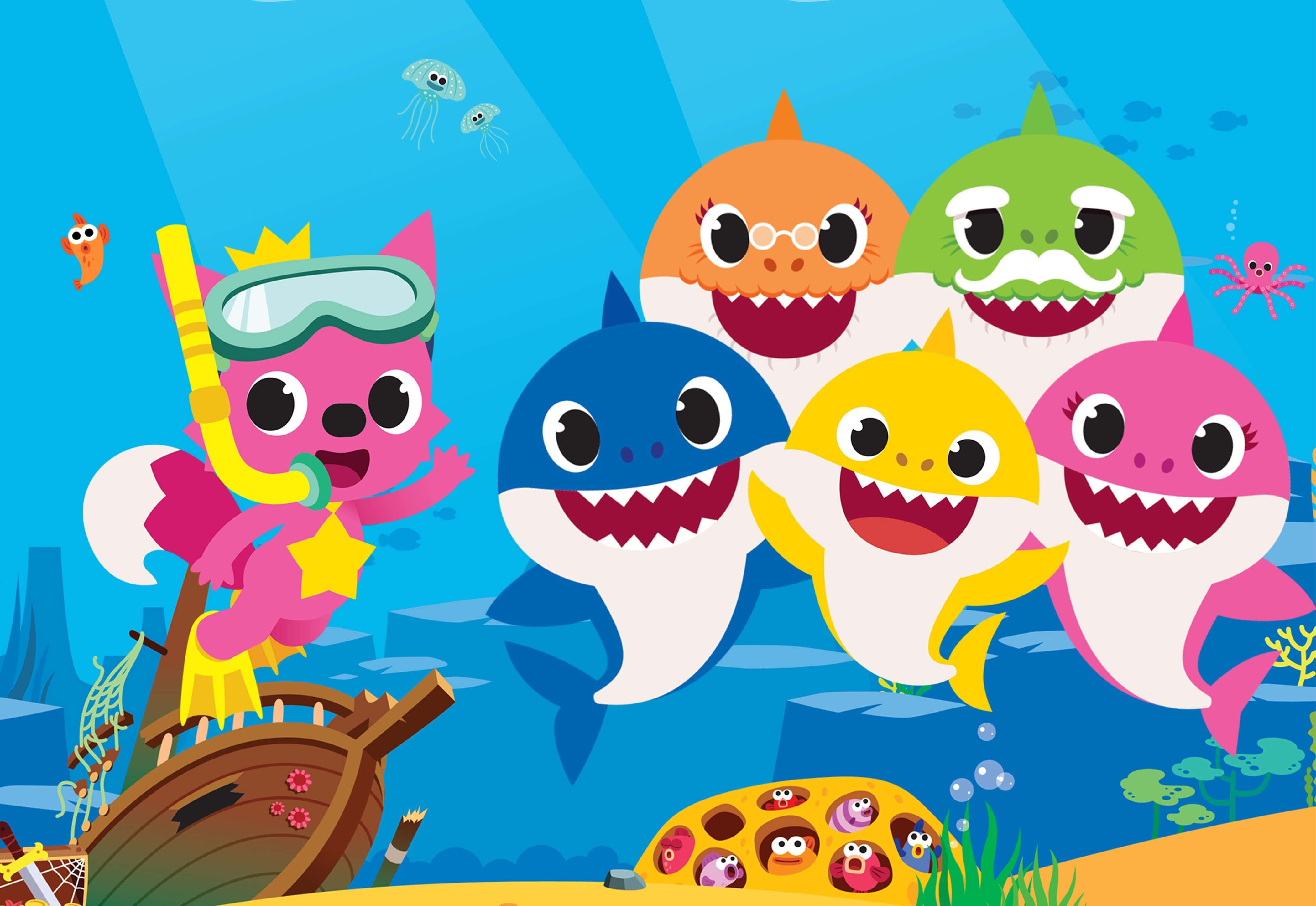 baby shark 桌布 壁紙 — 色彩繽紛的卡通鯊魚和一隻粉紅色狐狸潛水員探索一個陽光普照的水下世界，其中有沉船和水母。
