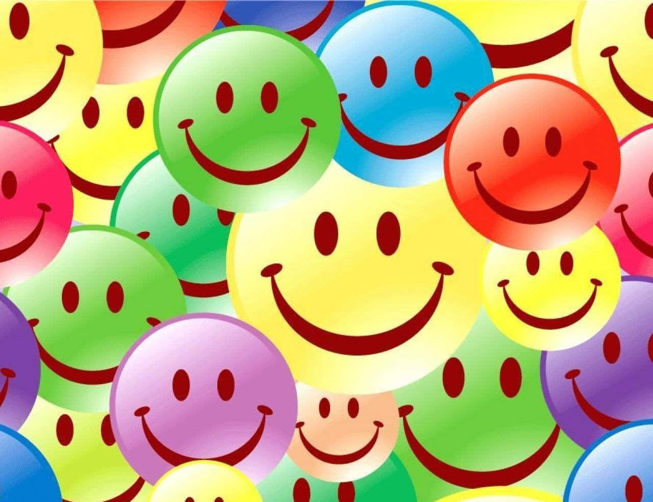 Smiley 桌布 壁紙 — 色彩繽紛的彩虹色亮面笑臉以歡樂混亂的圖案重疊。