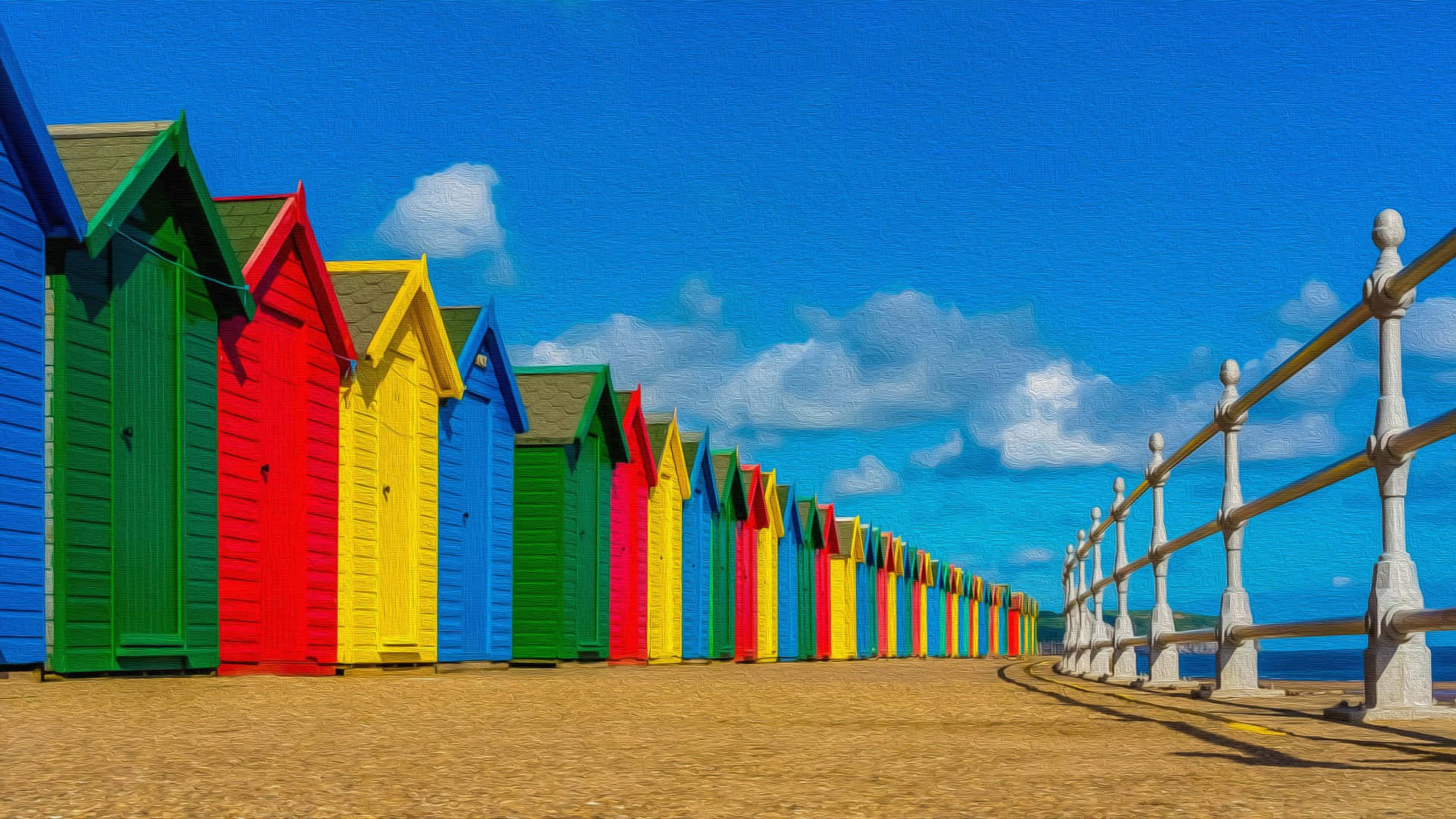 Beach Huts 桌布 壁紙 — 色彩繽紛的彩虹色海灘小屋排列在沙灘上，上方是明亮的藍天和蓬鬆的白雲。