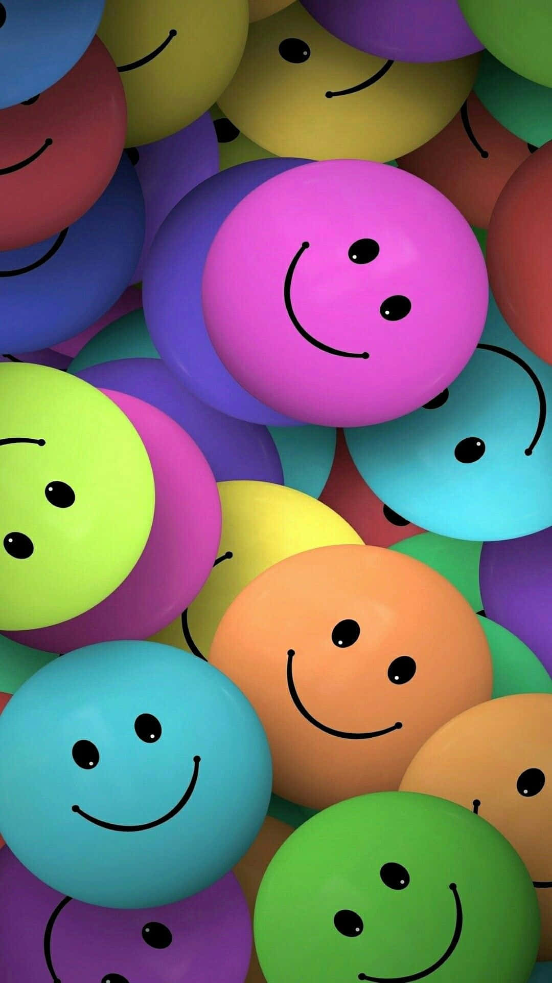 Happy iPhone 桌布 壁紙 — 色彩繽紛的球體特寫，帶有簡單的笑臉，營造出歡快俏皮的圖案。