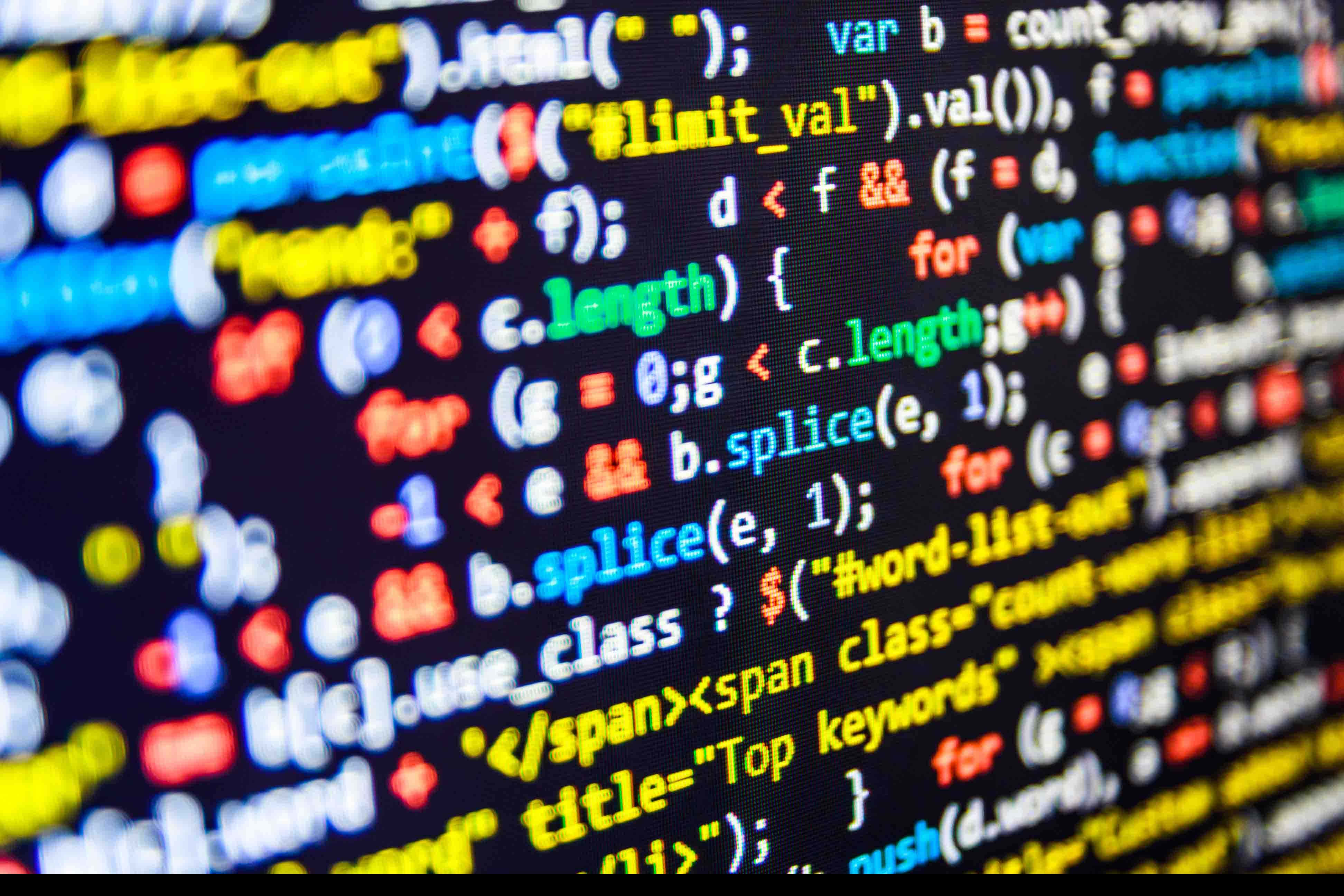 Programming 桌布 壁紙 — 色彩繽紛的程式碼線條在黑暗的螢幕上發光，景深較淺。