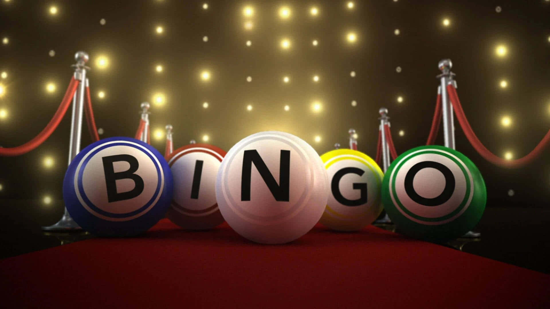Bingo 桌布 壁紙 — 色彩繽紛的賓果球拼出「bingo」字樣，放置在紅地毯上，兩旁有欄杆，上方閃爍著燈光。
