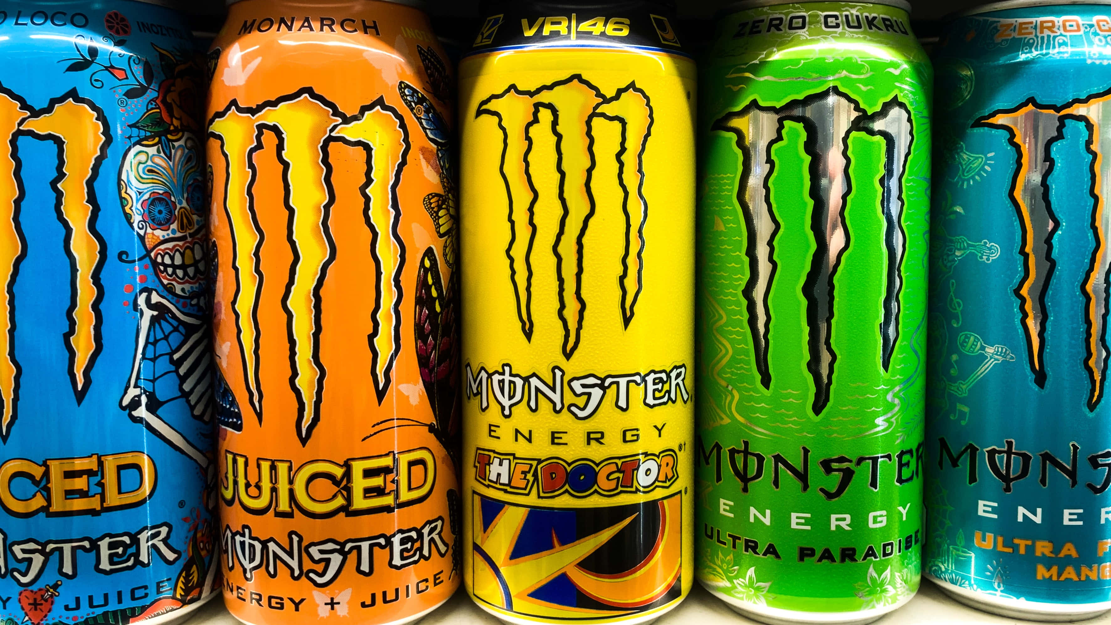 Monster Energy 桌布 壁紙 — 色彩鮮豔的Monster Energy飲料罐排列，展示獨特口味變體。