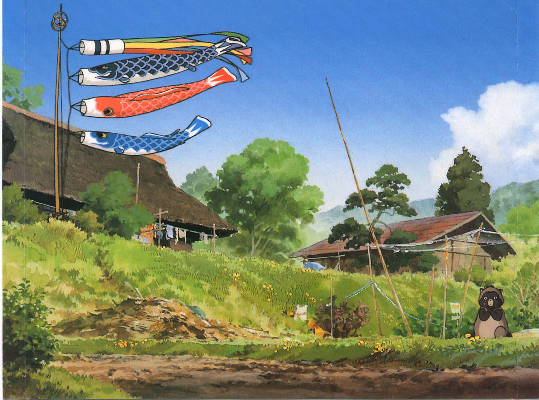 pom poko 桌布 壁紙 — 色彩鮮豔的鯉魚旗在茅草屋頂和翠綠山丘的質樸日本村莊上空，在清澈的藍天下飄揚。