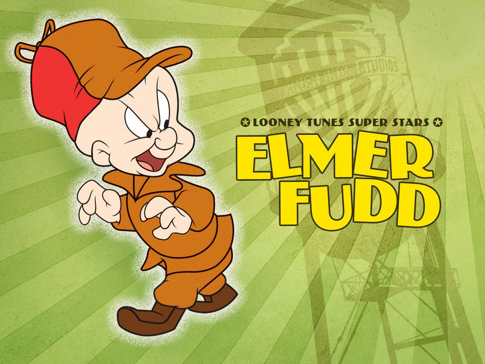 艾爾默·福德文字藝術 WB 壁紙 — Looney Tunes Super Stars 嘅 Elmer Fudd 以動感姿勢企喺綠色放射背景前，背景有褪色嘅 Warner Bros. 塔剪影。
