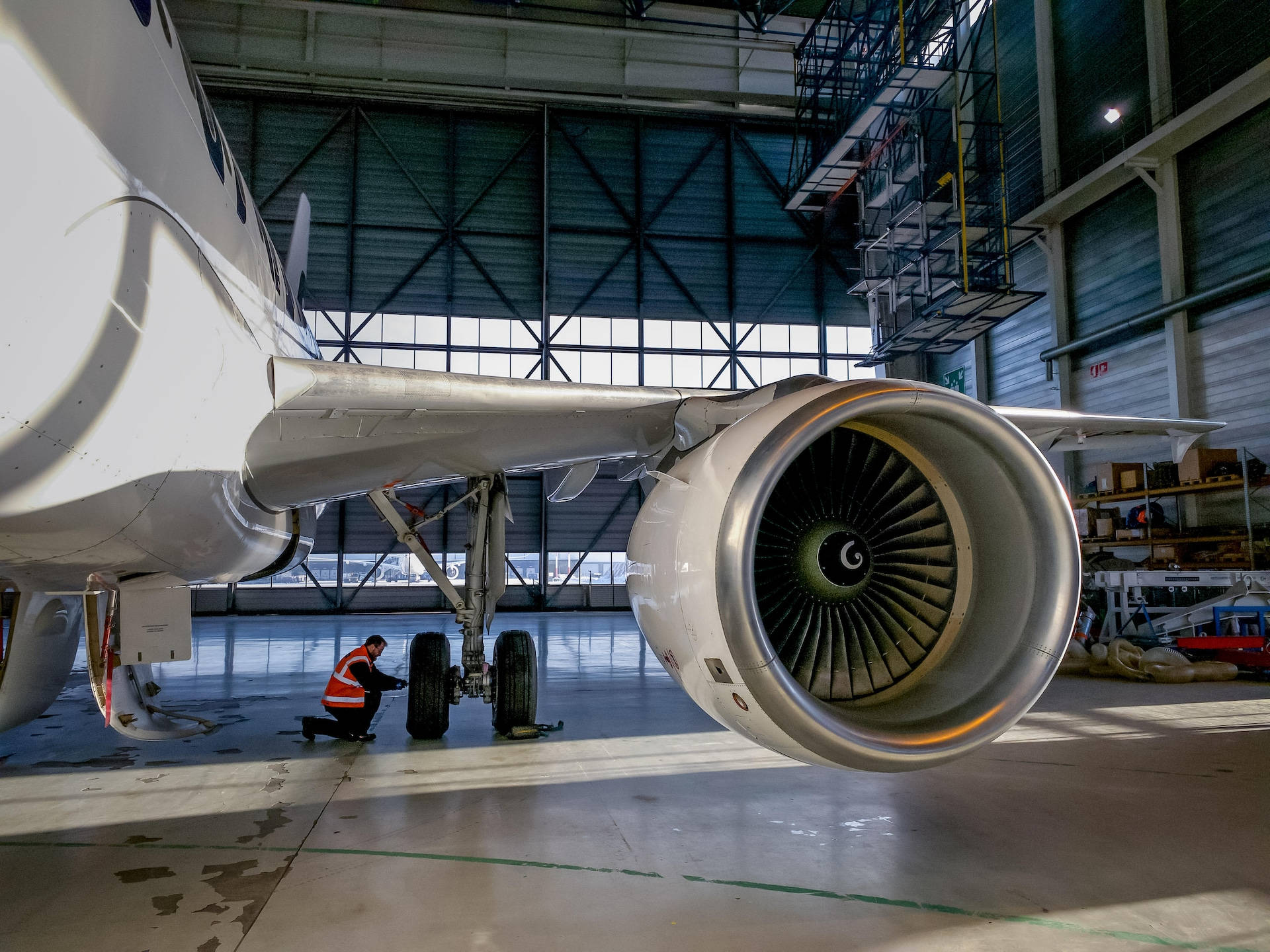 技術員在機庫內維修飛機起落架