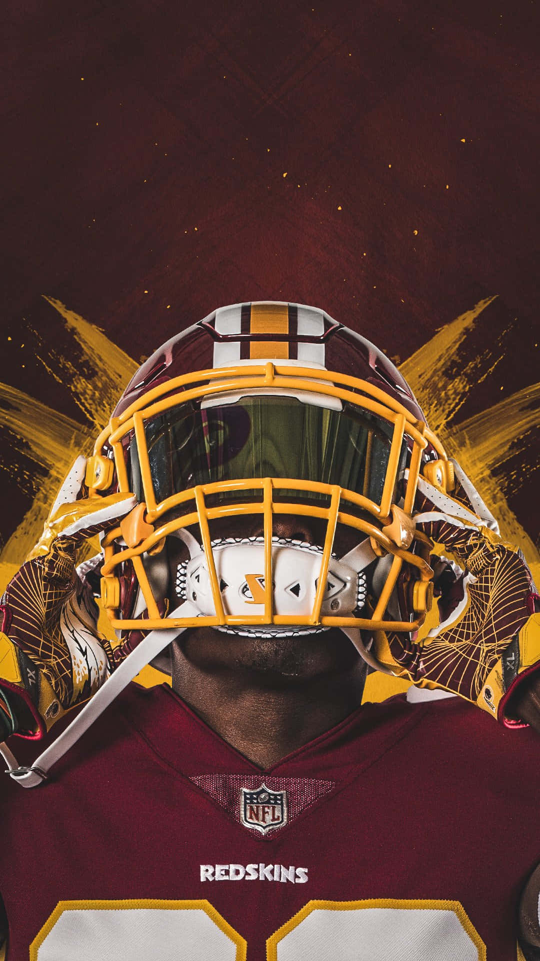 Washington Football 桌布 壁紙 — 華盛頓紅皮隊美式足球員的特寫，身穿栗色和金色頭盔及球衣，背景為帶有金色筆觸的紋理深紅色。