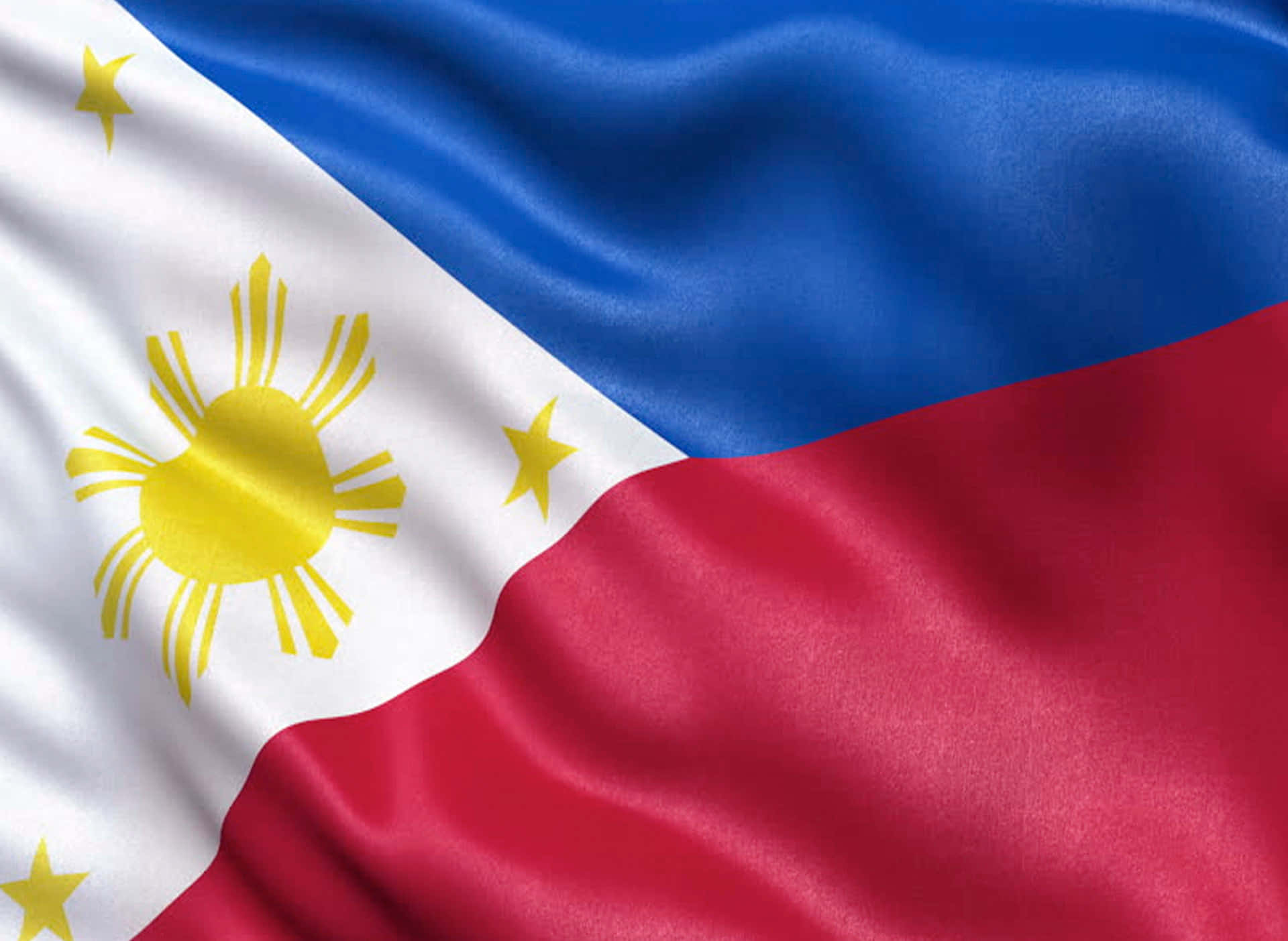 Philippines 桌布 壁紙 — 菲律賓國旗近距離特寫，飄揚著鮮豔的藍、白、紅色彩以及金色的太陽和星星。