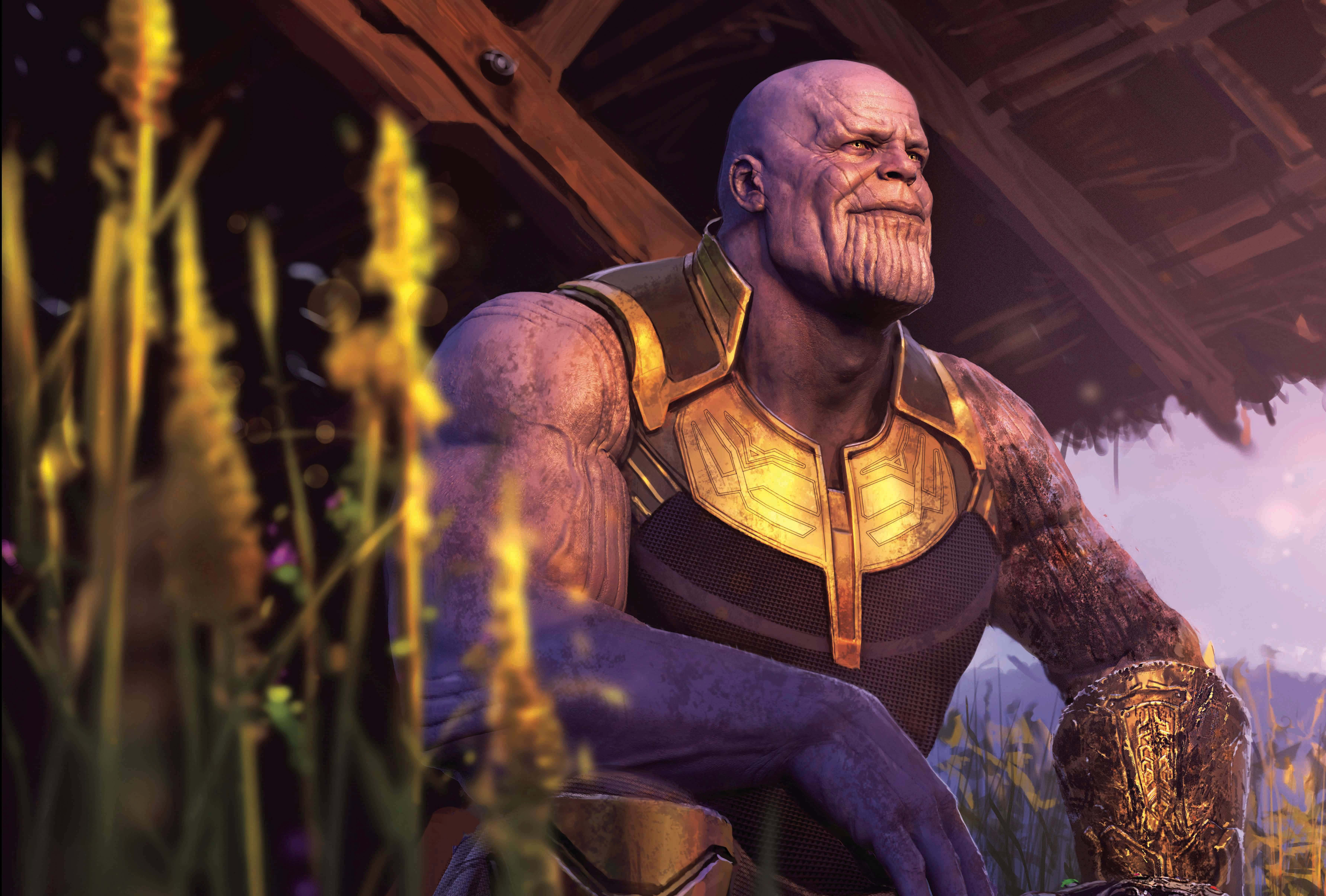 Thanos 桌布 壁紙 — 薩諾斯在暮色天空下的一片高聳金色草地上沉思地坐著，身穿他標誌性的金色和黑色盔甲。