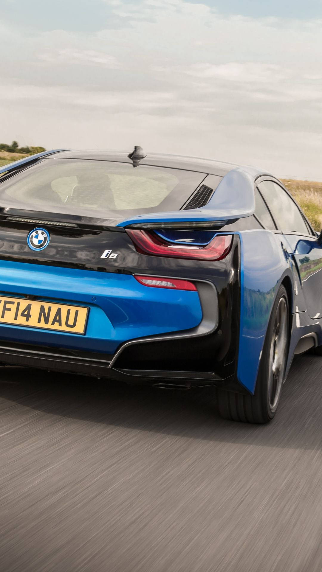 藍色BMW i8電動跑車在鄉村道路上疾馳。