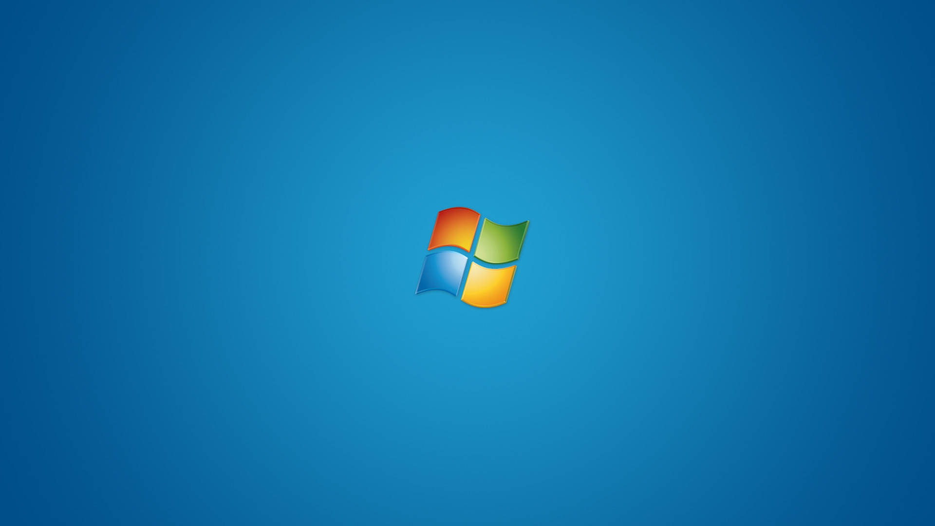 藍色微軟Windows標誌桌面 壁紙 — Windows 標誌居中於純藍色漸變背景上。