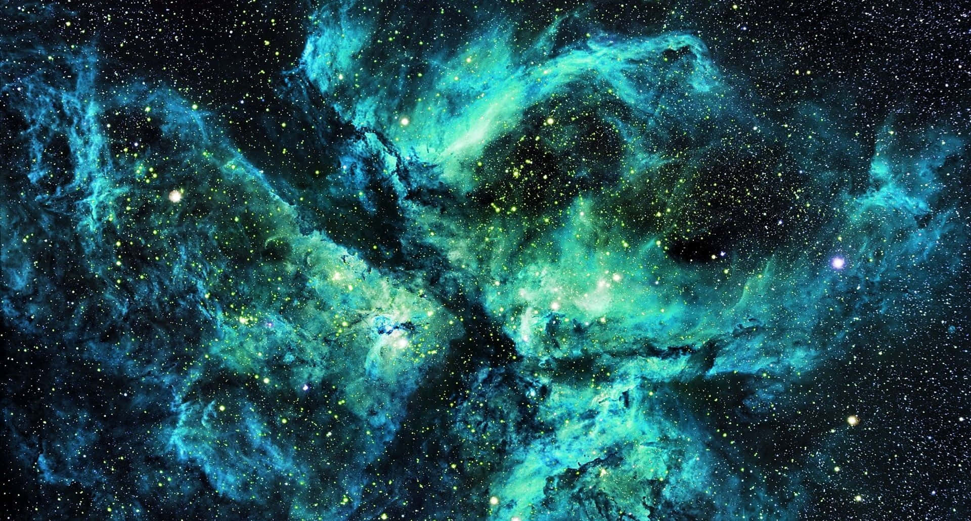 在浩瀚太空中，一個充滿星星的發光青綠色星雲。