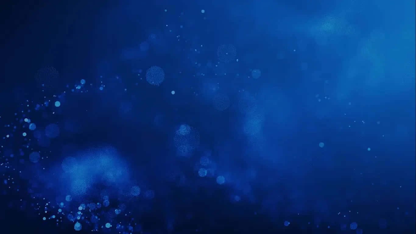 發光的藍色散景粒子漂浮在深邃的宇宙藍色虛空中。