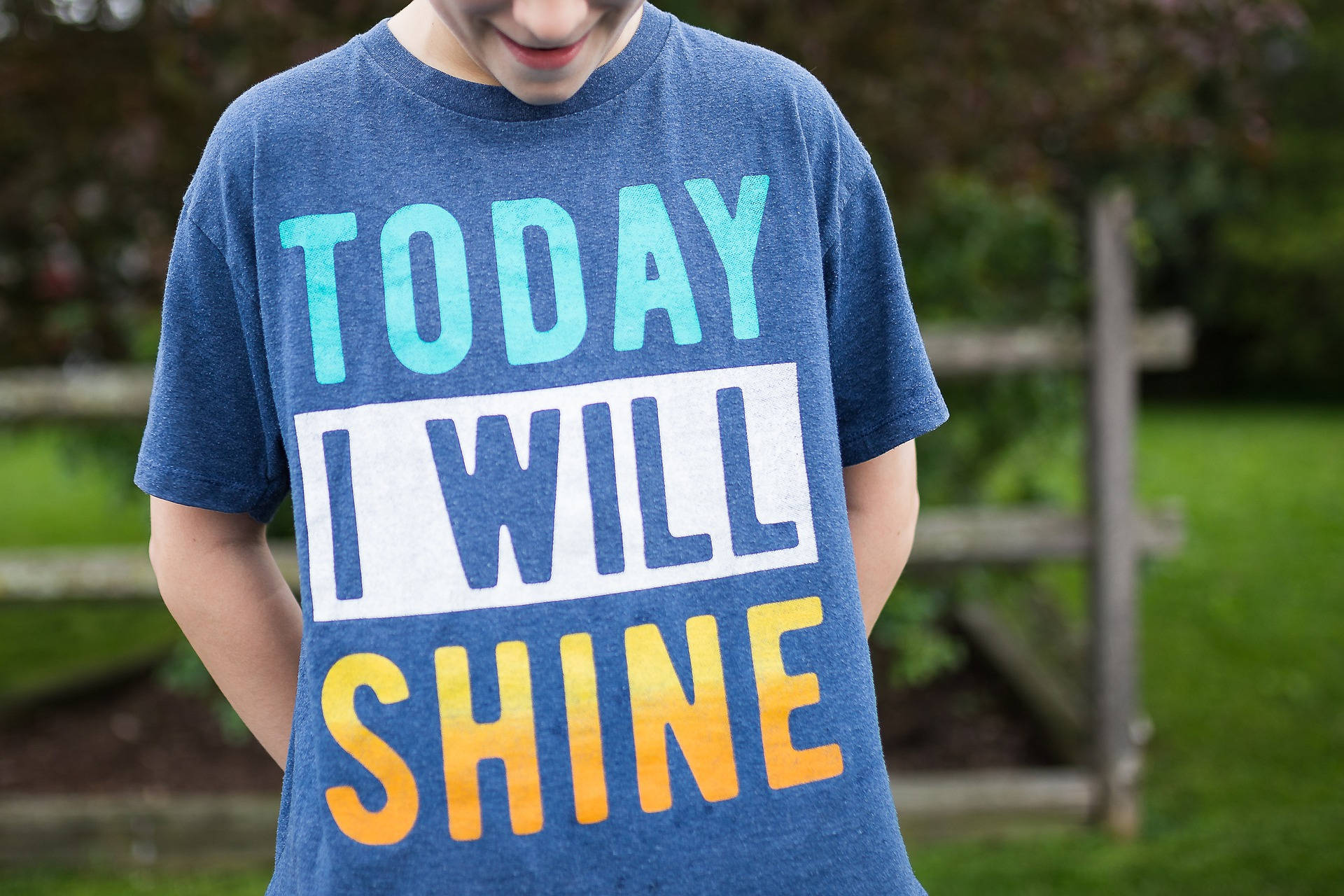 孩子穿著藍色T恤，上面寫著 today i will shine
