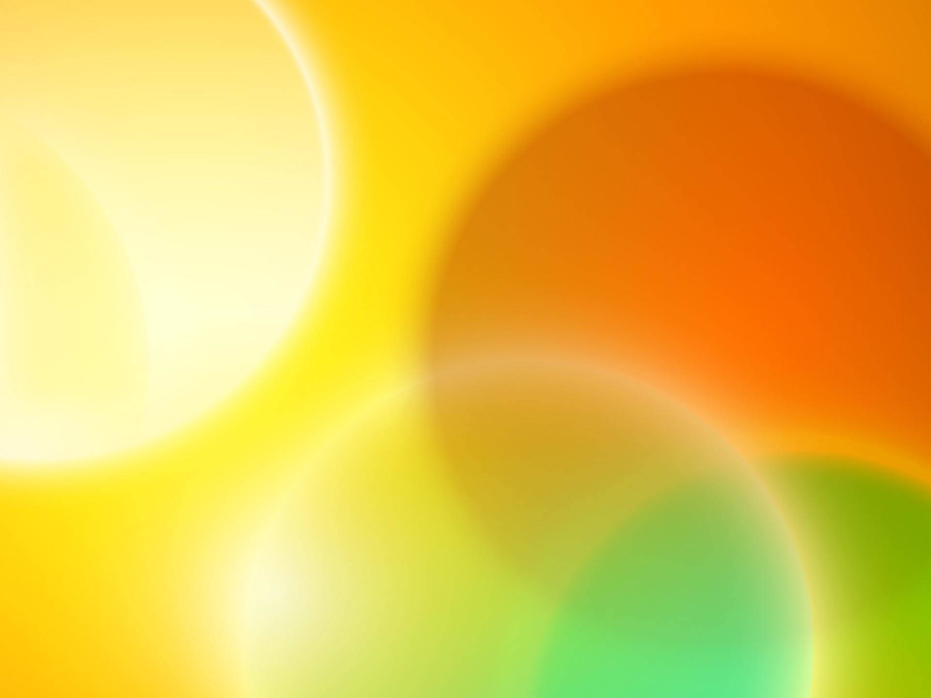 藝術感柔和光色圓圈 壁紙 — 柔和發光的球體，以溫暖的黃色、橙色和綠色調融合成夢幻般的抽象背景。