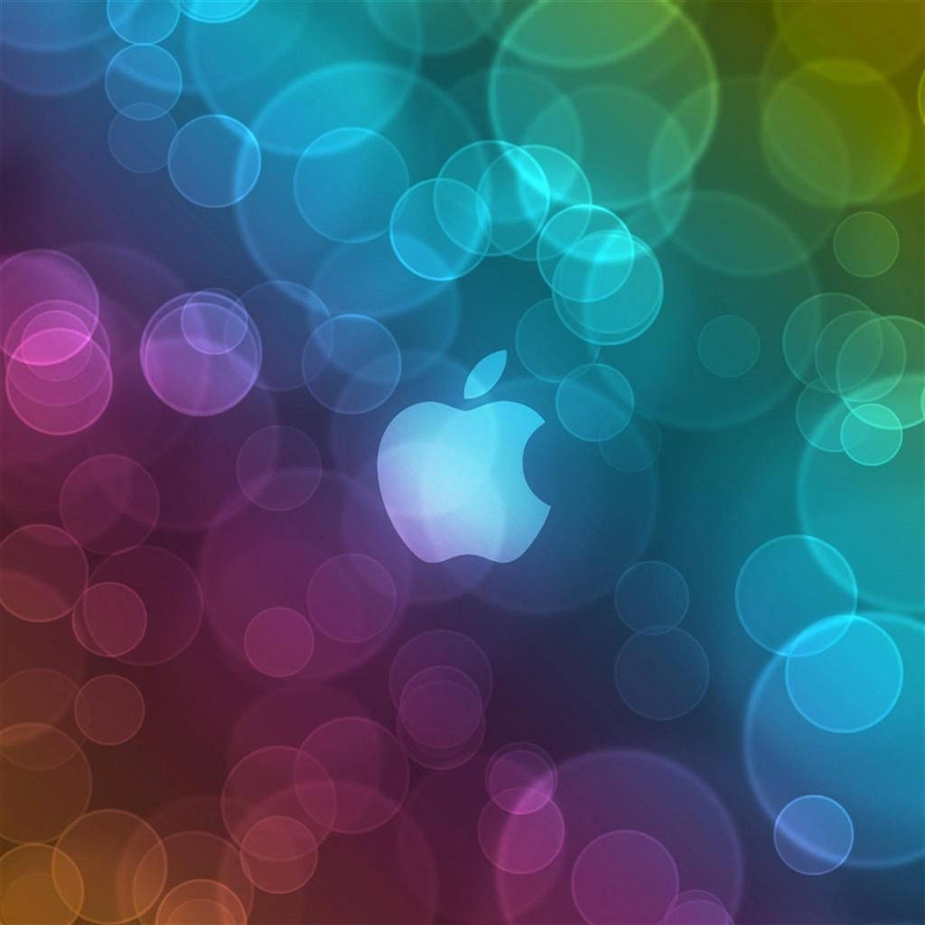 Apple標誌被色彩繽紛的發光圓圈包圍，背景為漸變色。