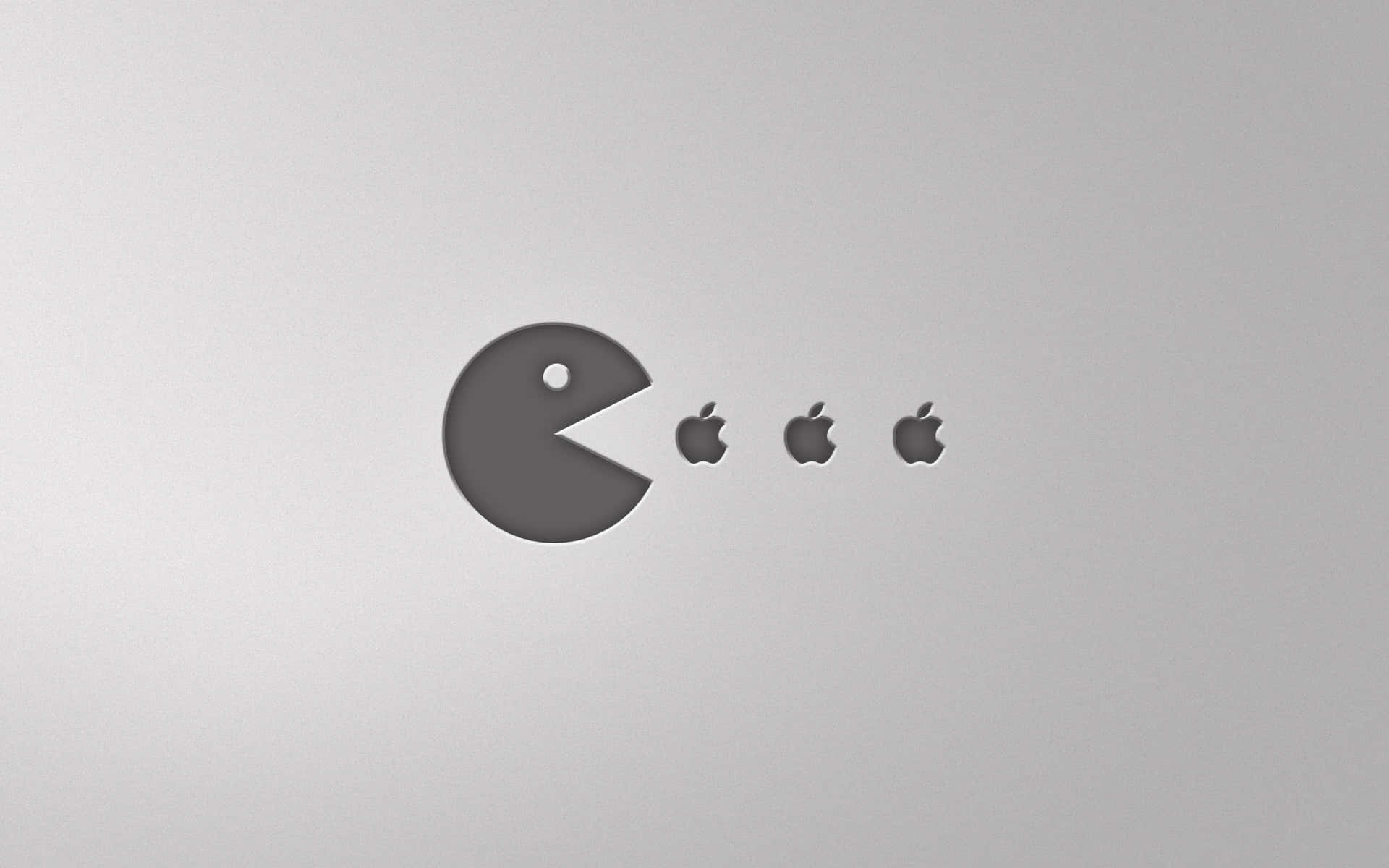 Pac-Man 在銀色表面上吃 Apple 標誌。