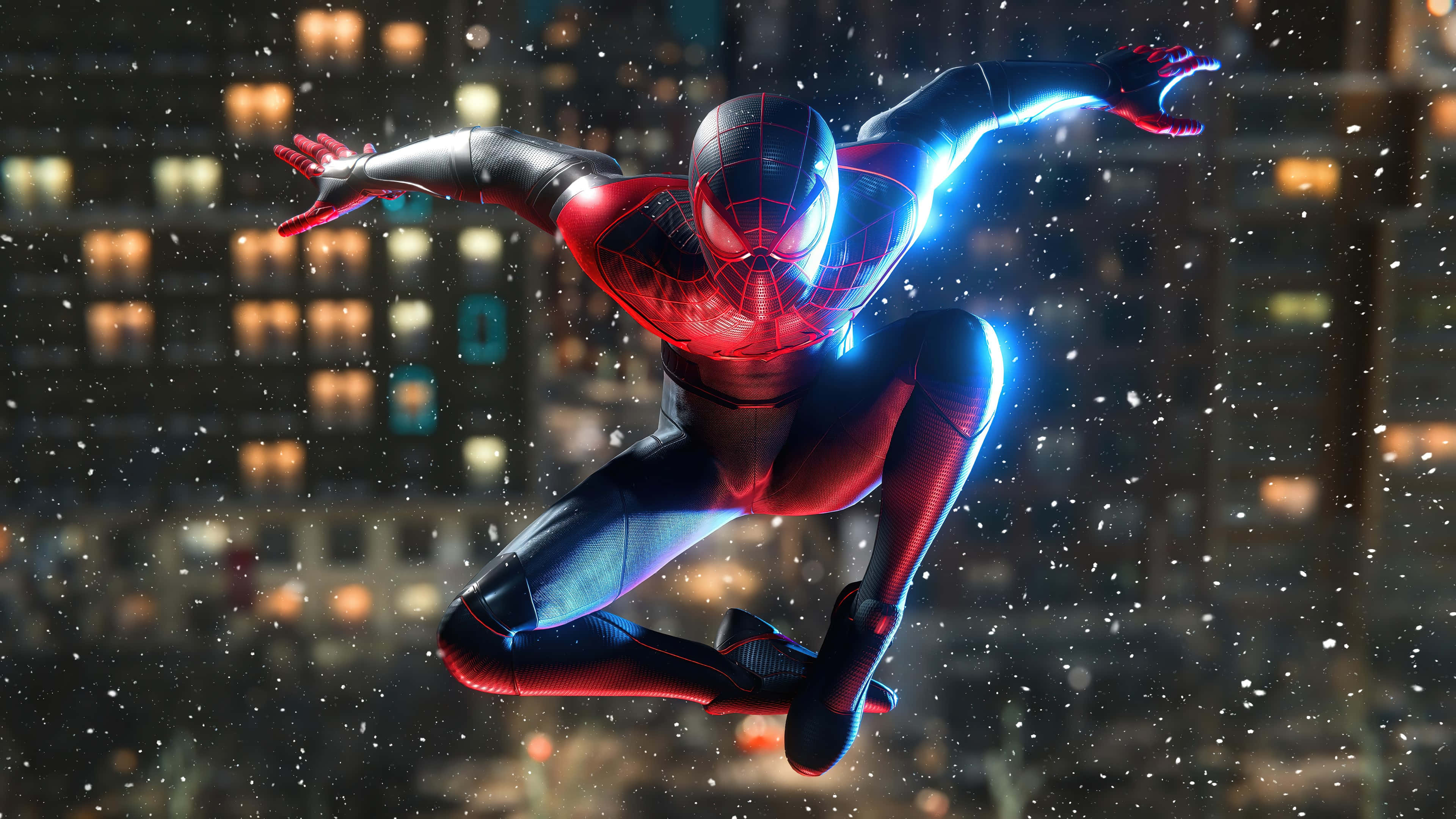 Superhero Video Games 桌布 壁紙 — 蜘蛛俠身穿紅藍戰衣，在夜間於積雪的城市景觀中擺盪，身後有發光的蛛網和燈火通明的建築物。