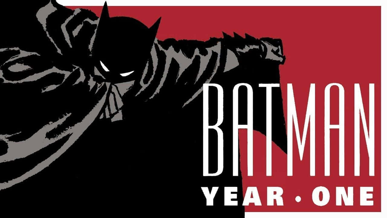 Batman Year One 桌布 壁紙 — 蝙蝠俠以動態的黑灰剪影，在一個大膽的紅色背景上跳躍，背景上有白色文字寫著「BATMAN YEAR ONE」。