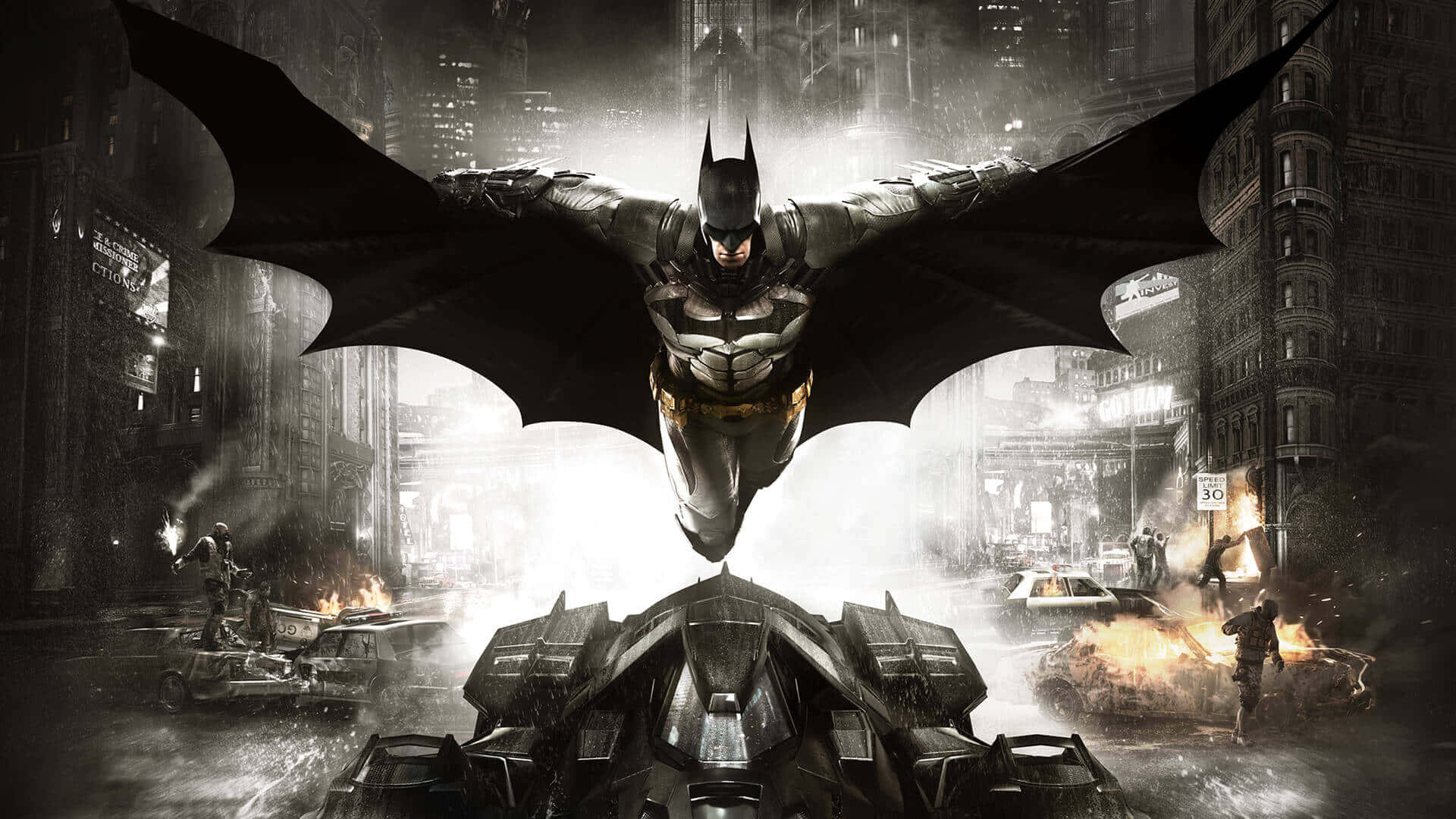 Superhero Video Games 桌布 壁紙 — 蝙蝠俠在濕漉漉的高譚市街道上空張開斗篷翱翔，下方爆炸與混亂爆發。